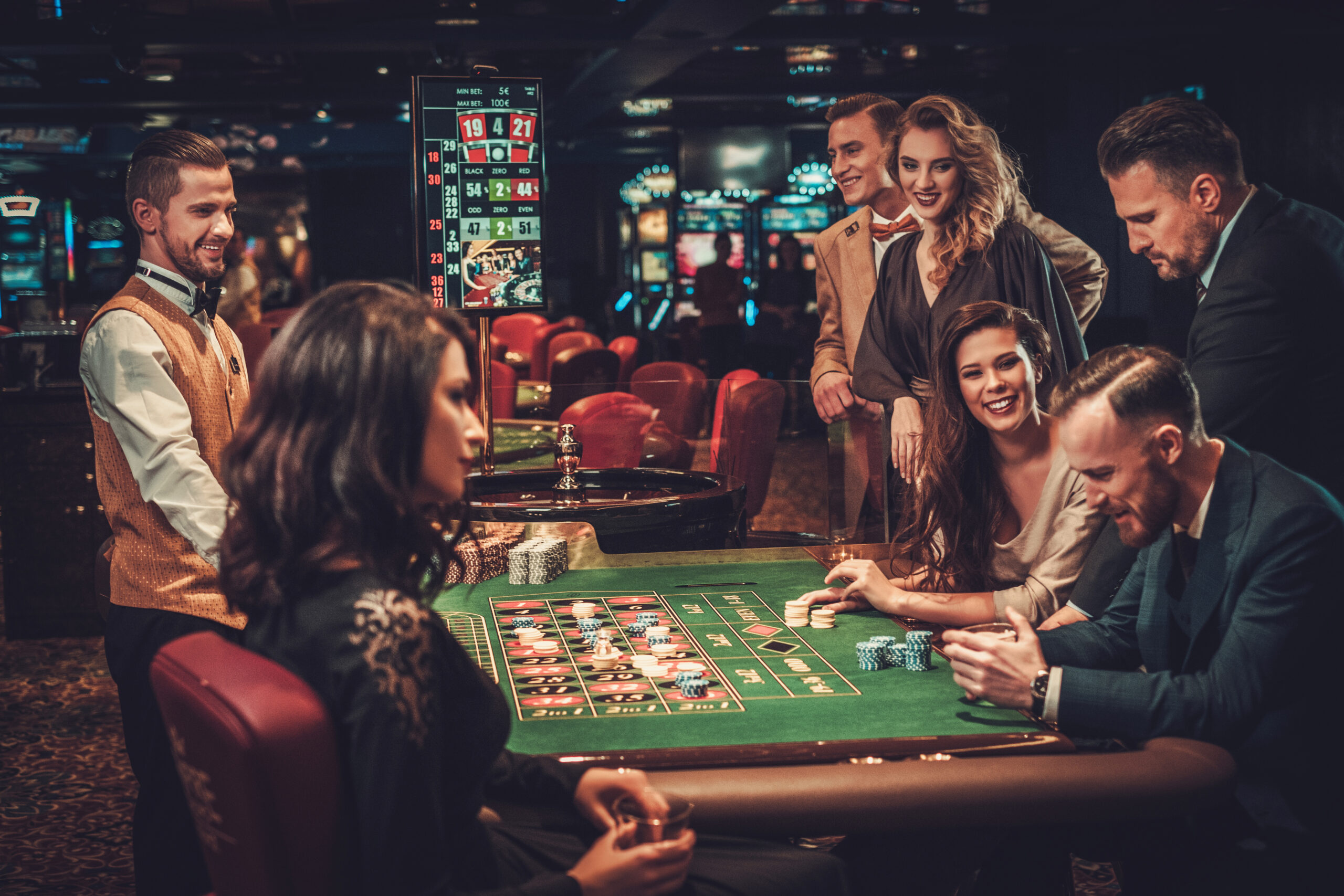 Upper class friends gambling in a casino.